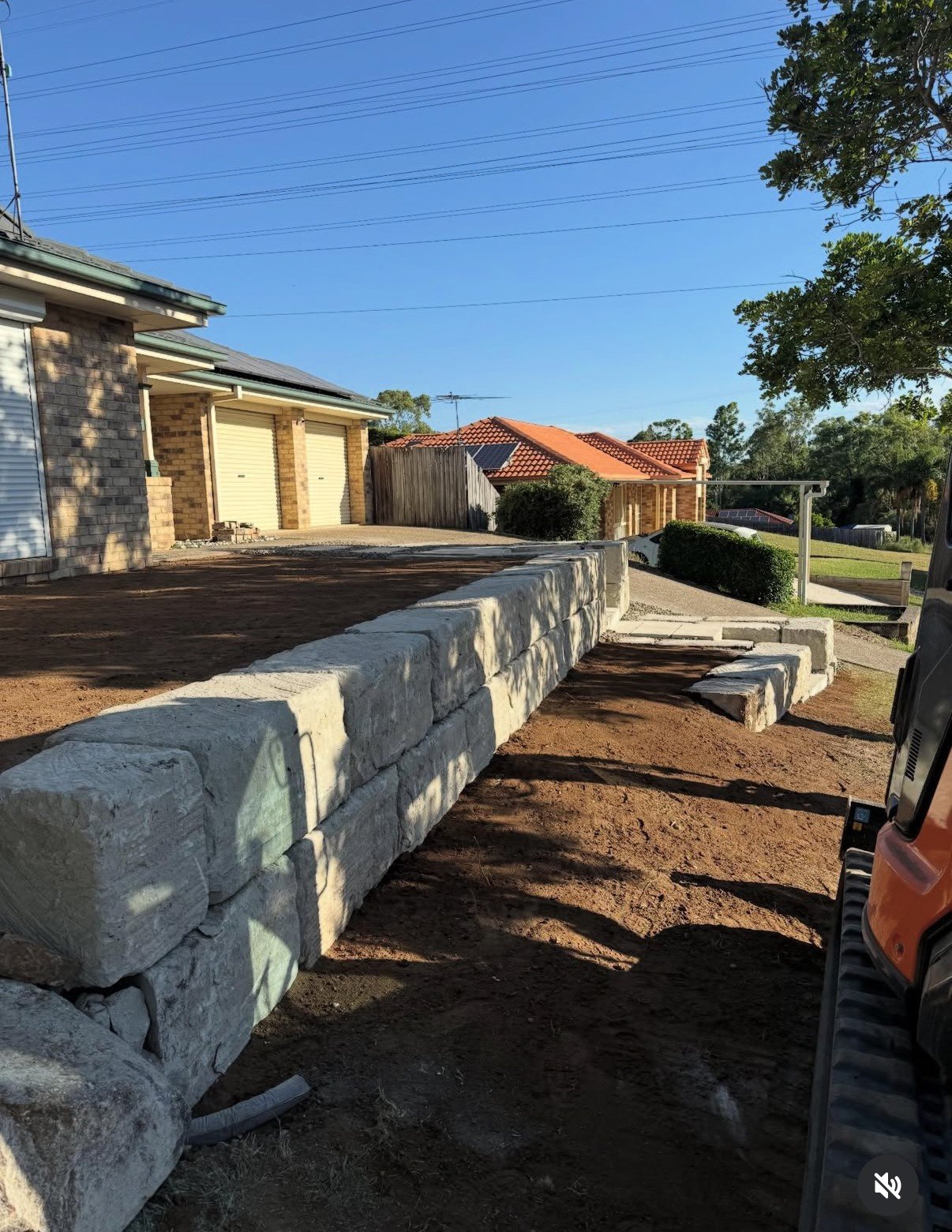Long sandstone rockwall built alongside residential driveway in Jimboomba